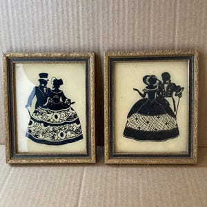 Vintage reverse painting silhouette flat glass of a man & woman pictures in a set of two.