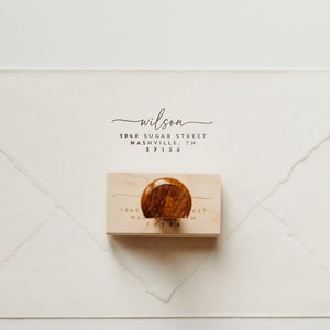 May include: A wooden return address stamp with the text "wilson 1848 Sugar Street Nashville, TN 37212" in black ink.