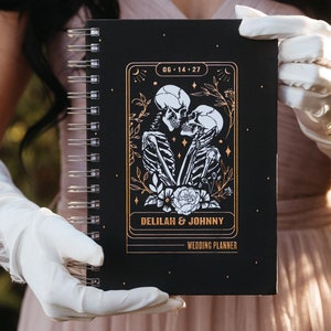 wedding planner book with illustration of The Lovers skeleton tarot