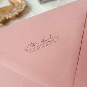 May include: A pink envelope with a return address label that reads "Tess + clerk + 1948 Sugar Street + Nashville, TN 37138".