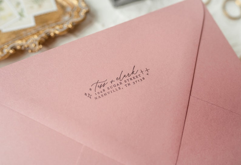 May include: A pink envelope with a return address label that reads "Tess + clerk + 1948 Sugar Street + Nashville, TN 37138".