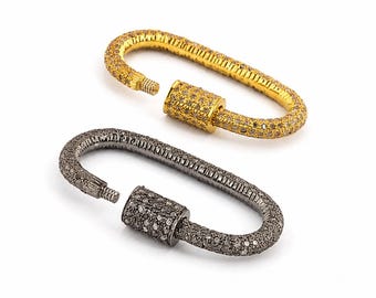 May include: Two oval-shaped screw-lock carabiner clasps, one in a bright gold tone and one in a dark gunmetal gray tone. Both clasps are covered in small, sparkling pavé-set stones and feature a threaded screw mechanism for secure closure.