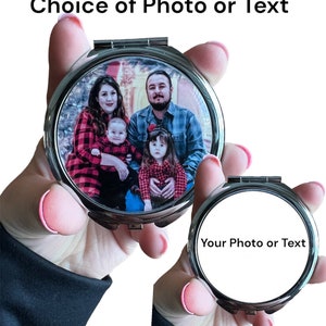 May include: A silver compact mirror with a family photo inside, held in a person's hand. The mirror's lid is open, revealing a color photo of a family of four. The text "Choice of Photo or Text" is above the mirror. A second mirror is also shown with the text "Your Photo or Text".