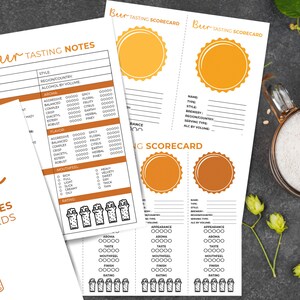 May include: White paper beer tasting notes and scorecards with orange accents. The text "Beer Tasting Notes & Scorecards" is visible. The scorecards have spaces for appearance, taste, and finish.