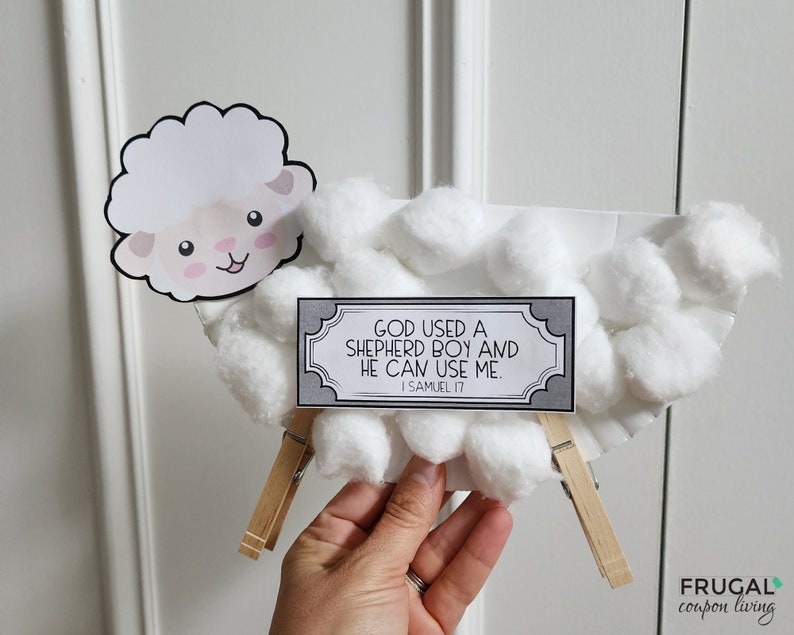 May include: A white paper plate craft depicting a sheep with cotton balls for wool. A sign with the text "GOD USED A SHEPHERD BOY AND HE CAN USE ME. I SAMUEL 17" is attached to the sheep.