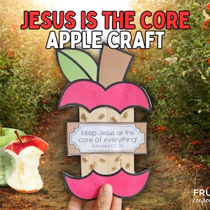 May include: A red apple craft with a cut-out core. The core is filled with wooden sticks and the text "Keep Jesus at the core of everything! Ephesians 1:22-23" is written on a white tag.