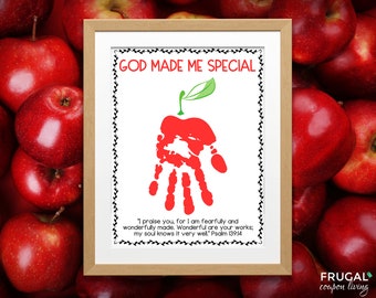 May include: A framed print with a red handprint in the shape of an apple with a green stem and leaf. The text "GOD MADE ME SPECIAL" is at the top of the print. The text "I praise you, for I am fearfully and wonderfully made. Wonderful are your works; my soul knows it very well" Psalm 139:14 is at the bottom of the print.