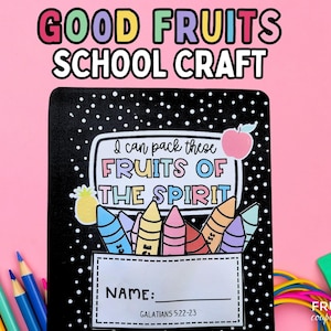 May include: A black notebook with white polka dots, featuring the text "Good Fruits School Craft." The cover includes the phrase "I can pack these Fruits of the Spirit" with crayon illustrations and a space for a name. A pink background.