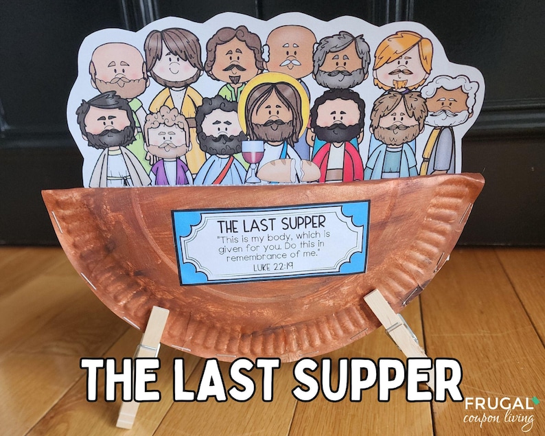 May include: A brown paper plate with a scene depicting the Last Supper. The plate is propped up on two wooden clothespins. The scene includes Jesus and his disciples, with the text "THE LAST SUPPER" and a quote from Luke 22:19.