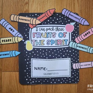 May include: A black notebook with white polka dots and the text "I can pack these FRUITS OF THE SPIRIT." Colourful crayon cutouts spell out words like "Joy," "Peace," and "Love." A pineapple and apple sticker are also included.