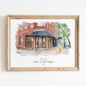 May include: A framed watercolor print depicting a red brick building with a storefront labeled Gong cha. The artwork features a dark awning, a yellow fire hydrant, and a tree. Below the illustration, the text reads: Gong cha, where it all began, 7/9/24.