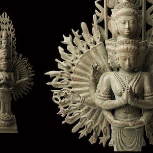 May include: A bronze sculpture of a multi-armed deity with multiple heads, each with a serene expression. The deity is surrounded by a halo of radiating arms, each ending in a hand gesture. The sculpture is a traditional representation of a Buddhist deity.