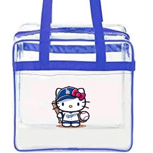May include: Transparent tote bag with blue edging and handles. It features a cartoon Hello Kitty in a Dodgers baseball uniform, holding a bat and ball. The bag has a zip closure and is designed for carrying items.