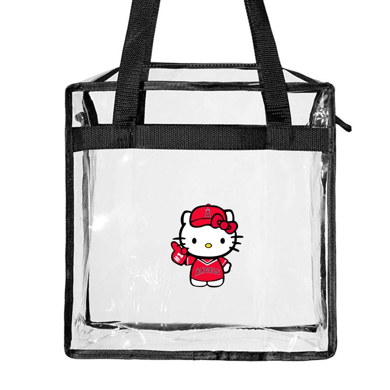 May include: Clear plastic tote bag with black handles and a zipper closure. The bag features a Hello Kitty graphic wearing a Los Angeles Angels baseball cap and jersey.