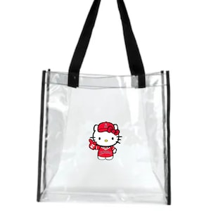 May include: Clear plastic tote bag with black handles and a red Hello Kitty graphic wearing a baseball cap and jersey with the word "Angels" on it.