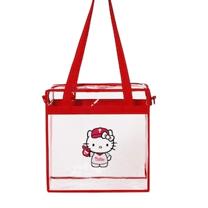 May include: Clear red and white tote bag with a Hello Kitty graphic wearing a Philadelphia Phillies baseball cap and holding a baseball glove. The text "Phillies" is on the shirt.