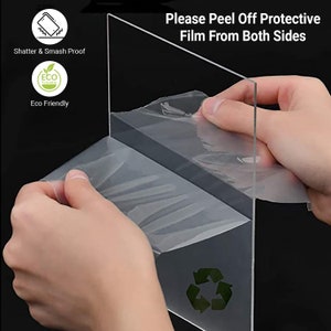 Puede incluir: Una l&aacute;mina de acr&iacute;lico transparente con una pel&iacute;cula protectora en ambos lados. La pel&iacute;cula se est&aacute; despegando para revelar la l&aacute;mina de acr&iacute;lico transparente. El texto "Please Peel Off Protective Film From Both Sides" est&aacute; impreso en la l&aacute;mina.