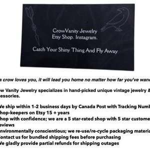 May include: A black business card with white text and a crow illustration. The card reads "CrowVanity Jewelry, Etsy Shop, Instagram." and "Catch Your Shiny Thing And Fly Away." The card also includes a quote and information about the shop.