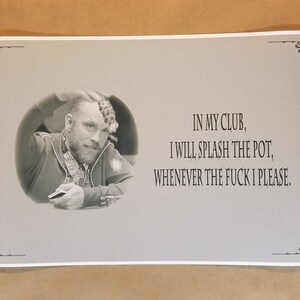 May include: A grayscale print featuring a man in a poker setting, with text that reads "IN MY CLUB, I WILL SPLASH THE POT, WHENEVER THE FUCK I PLEASE." The print has decorative corner elements.