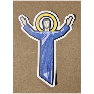 May include: A die-cut sticker featuring a stylized figure with a beard and long hair, wearing a blue robe with a geometric pattern. The figure has arms raised upward and a bright yellow circular halo behind the head, outlined in thick black.