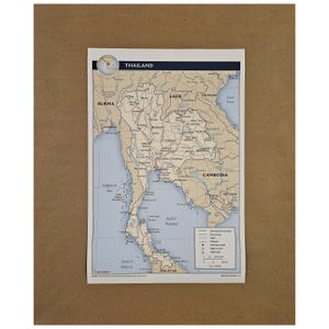 May include: A detailed map of Thailand, featuring surrounding countries and bodies of water. The map includes labels for cities, geographical features, and international boundaries. The title "THAILAND" is displayed at the top.