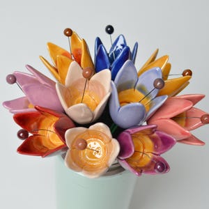 Colourfull, hand-made, lovely ceramic flowers: tulip, avaiable in 8 colours. 
They are fixed on a green wire (l=20cm), you can put them in a vase, next to your inside plant or outside.