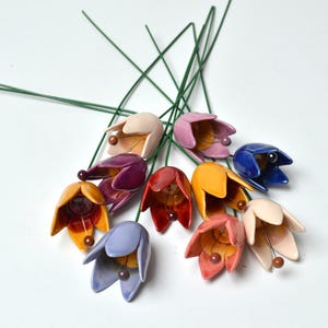 Colourfull, hand-made, lovely ceramic flowers: tulip, avaiable in 8 colours. 
They are fixed on a green wire (l=20cm), you can put them in a vase, next to your inside plant or outside.