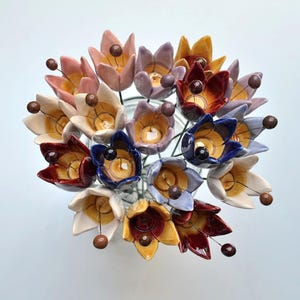 Colourfull, hand-made, lovely ceramic flowers: tulip, avaiable in 8 colours. 
They are fixed on a green wire (l=20cm), you can put them in a vase, next to your inside plant or outside.