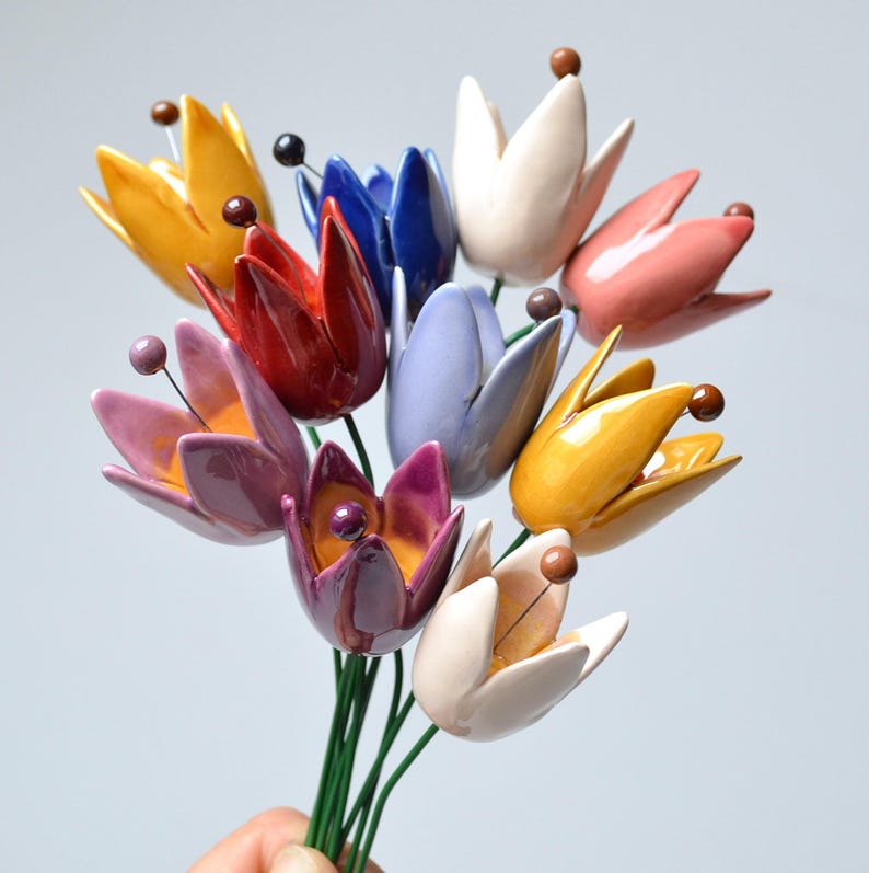 Colourfull, hand-made, lovely ceramic flowers: tulip, avaiable in 8 colours. 
They are fixed on a green wire (l=20cm), you can put them in a vase, next to your inside plant or outside.