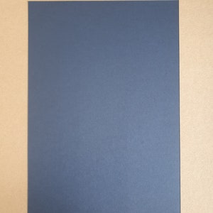 May include: A dark blue sheet of paper on a brown background.
