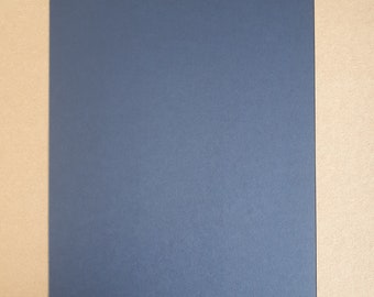May include: A dark blue sheet of paper on a brown background.