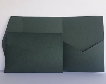 May include: A set of two dark green envelopes with a flap on the front. The envelopes are folded in half and have a textured surface.
