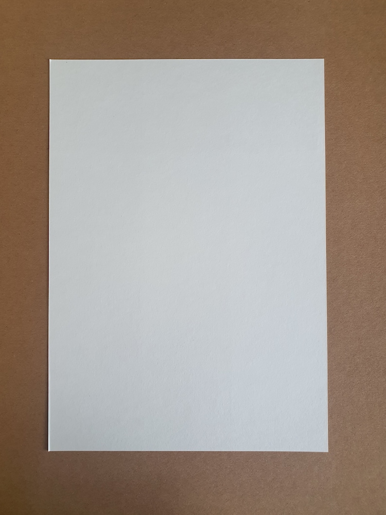 May include: A blank white sheet of paper on a brown background.