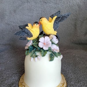 Bell shaped music box with yellow birds atop pink flowers, plays &quot;Enchanted Melodies Westland&quot;