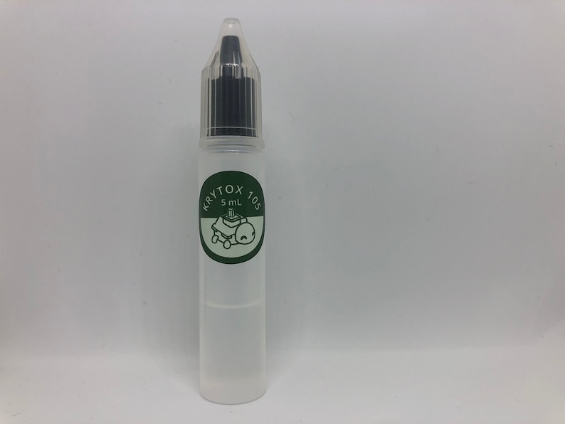 May include: A clear plastic bottle with a black dropper cap. The bottle is labeled "Krytox 105" and "5 mL".