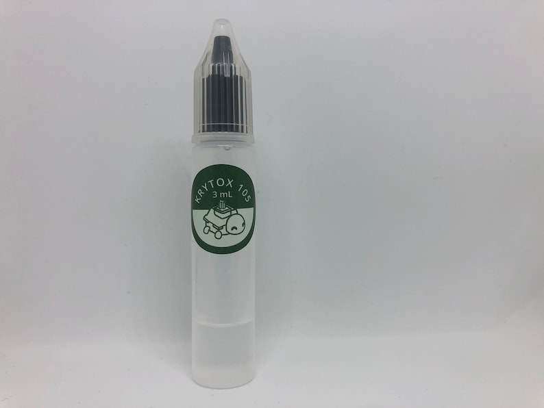May include: A clear plastic bottle with a dropper top. The bottle is labeled "Krytox 105" and "3 mL".