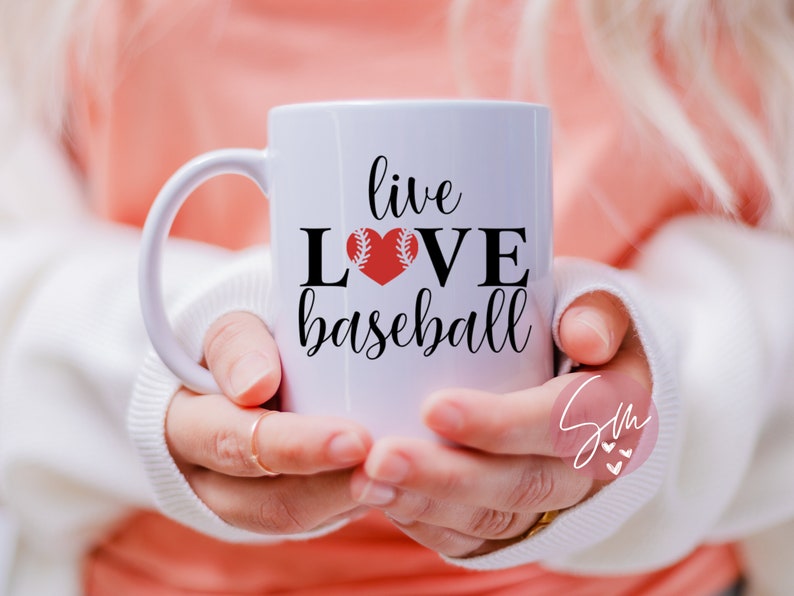 May include: White ceramic mug with a black and red design. The mug says "live love baseball" with a red baseball heart.