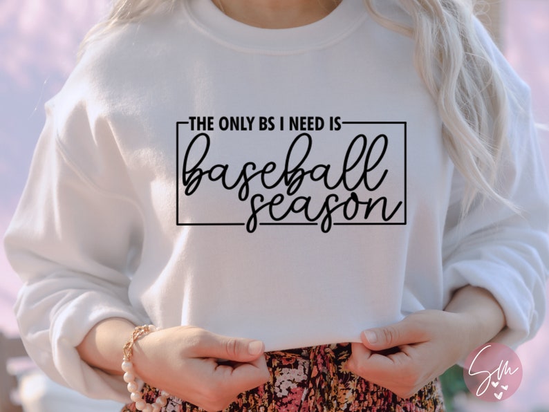 May include: White sweatshirt with black text that reads "The only BS I need is baseball season".