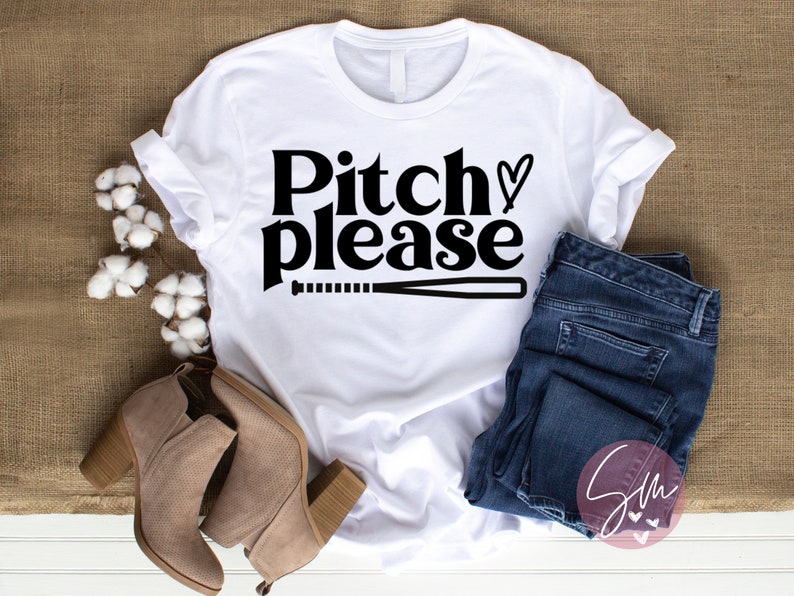 May include: White t-shirt with black text that says "Pitch please" with a baseball bat and a heart symbol.