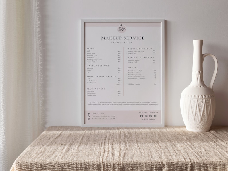 May include: A white framed price list for makeup services. The list includes bridal makeup, makeup lessons, photoshoot makeup, prom makeup, festival makeup, special fx makeup, and other services. The price list also includes contact information for the business.