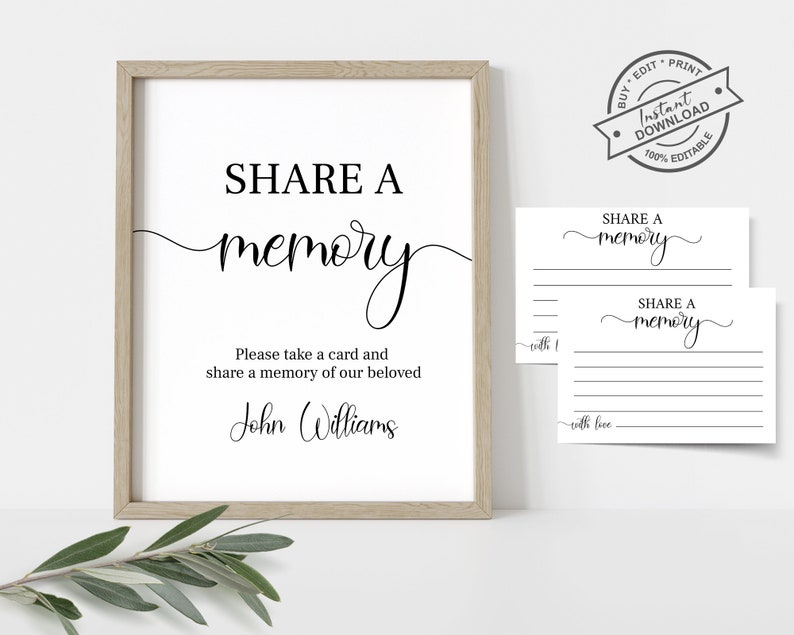 May include: A printable sign that says "Share a memory" with a space to write a memory of John Williams. The sign is in a white frame with a light wood finish. There are two blank cards with the same text, "Share a memory", for guests to write their memories.