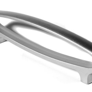 May include: A silver-toned, oval-shaped cabinet pull with a smooth, brushed finish. The pull has a contemporary design and is ideal for modern kitchens and bathrooms.