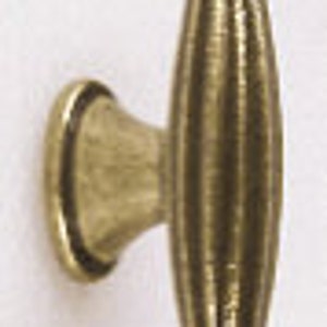 May include: A gold-toned cabinet knob with a fluted design and a rounded top.
