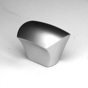 May include: A silver cabinet knob with a rounded top and a square base.