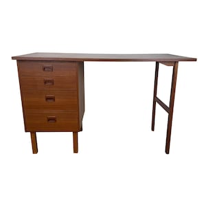 May include: A mid-century modern desk with a warm brown finish. The desk features a set of four drawers on the left side and a long, rectangular tabletop. The desk is supported by two legs on the right and two legs on the left.