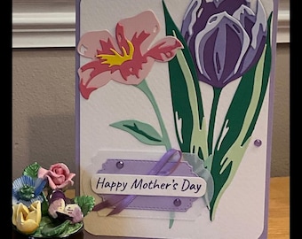 Celebrate Mother's Day with this beautifully handcrafted card, featuring vibrant spring flowers. Layers of card adding depth and dimension