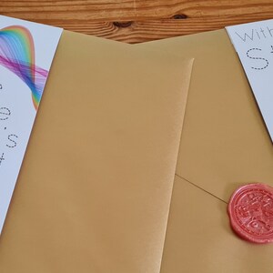 May include: Two bookmarks, one with a rainbow design and the text "The Game Master's Gambit" and dice, the other with a polar bear in armor and the text "Within The Story".