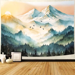 May include: A tapestry depicting a mountain landscape with a sunrise. The artwork features snow-capped mountains, layers of green and blue trees, and birds in flight. The color palette includes shades of blue, green, yellow, and white.
