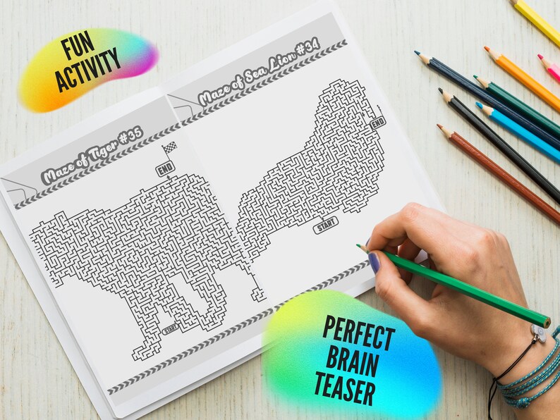 May include: A black and white maze book with two animal mazes, a tiger and a sea lion. The text "FUN ACTIVITY" and "PERFECT BRAIN TEASER" are on the image. A hand is holding a green colored pencil, ready to solve the maze.