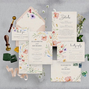 May include: A wedding stationery suite featuring cream-colored paper with watercolor floral illustrations. Includes an invitation, RSVP card, details card, thank you note, and envelope. Accessories include a wax seal stamp, gold wax, and a green ring box.
